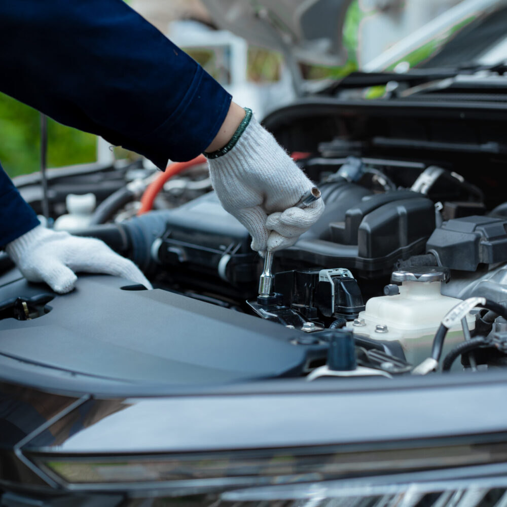 Asian male automotive technician who inspects, repairs, and main